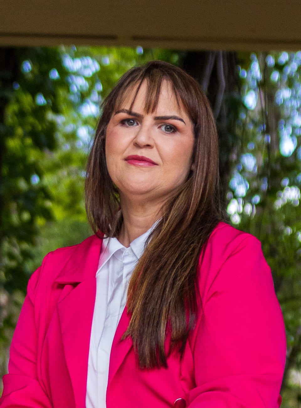 Ana Carla Moura, mentora da Mentoria Carreira no Turismo, com blazer rosa e camisa branca